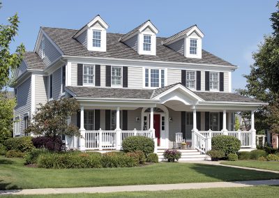 Large suburban home with front porch and arched entry